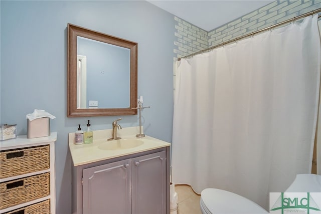 bathroom with tile patterned flooring, vanity, toilet, and curtained shower