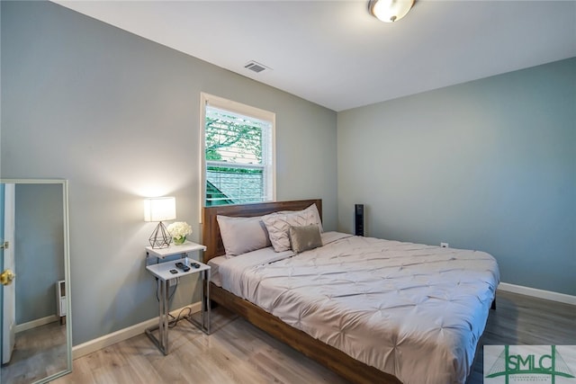 bedroom with hardwood / wood-style floors