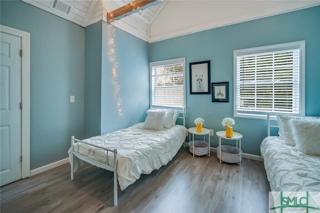 bedroom featuring hardwood / wood-style flooring and lofted ceiling