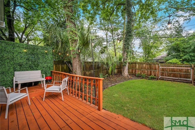 wooden terrace with a lawn