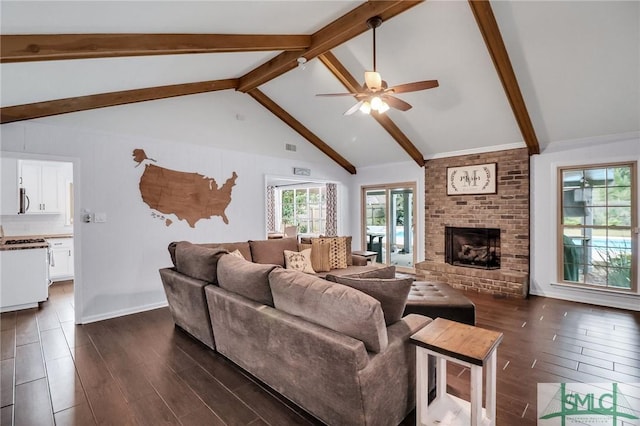 living room featuring ceiling fan, a fireplace, and vaulted ceiling