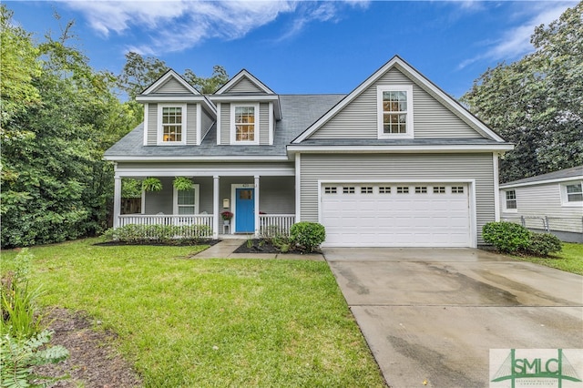 view of front of house featuring covered porch, a garage, and a front lawn