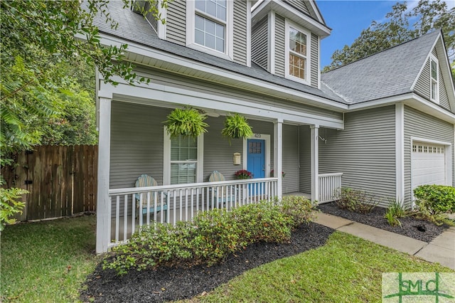 doorway to property featuring covered porch and a garage