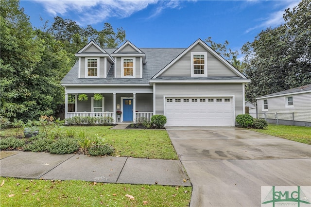 view of front of property featuring covered porch, a garage, and a front lawn