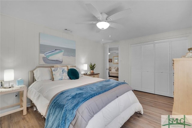 bedroom featuring ceiling fan, a closet, and hardwood / wood-style flooring