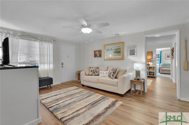 living room with ceiling fan and light hardwood / wood-style floors