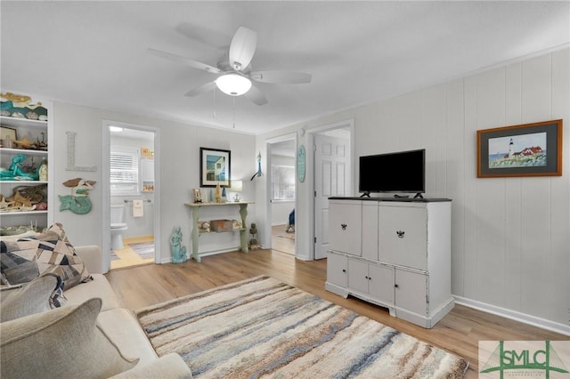 living room with ceiling fan, light hardwood / wood-style flooring, and crown molding