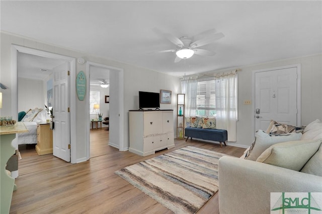 living room featuring ceiling fan and light wood-type flooring