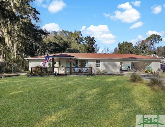 view of front of home featuring a carport, a front yard, a wooden deck, and stucco siding