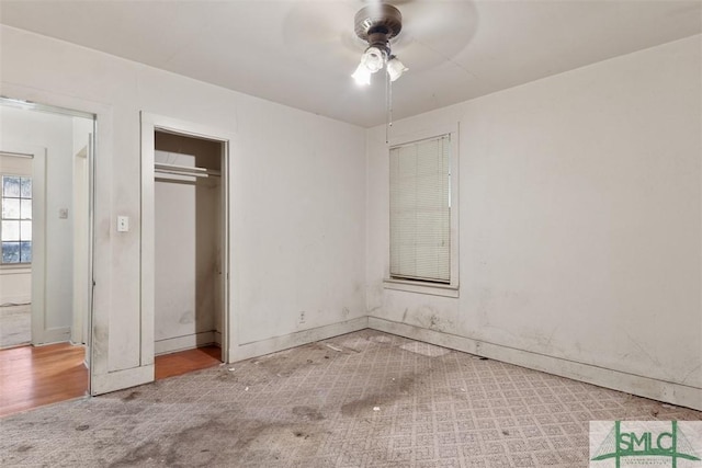 unfurnished bedroom with ceiling fan, a closet, and carpet