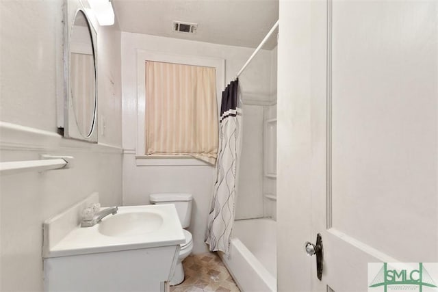 full bathroom featuring shower / tub combo, vanity, and toilet