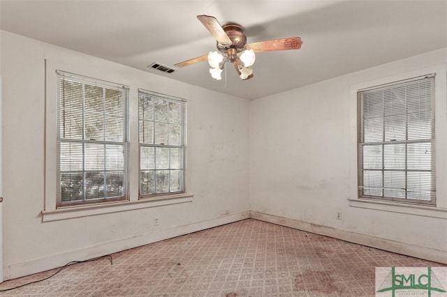 unfurnished room featuring ceiling fan and carpet