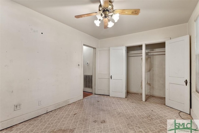 unfurnished bedroom with ceiling fan and multiple closets