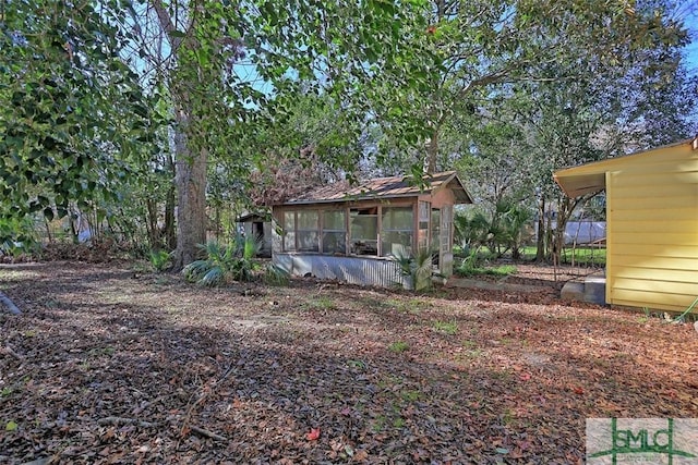 view of yard with a sunroom