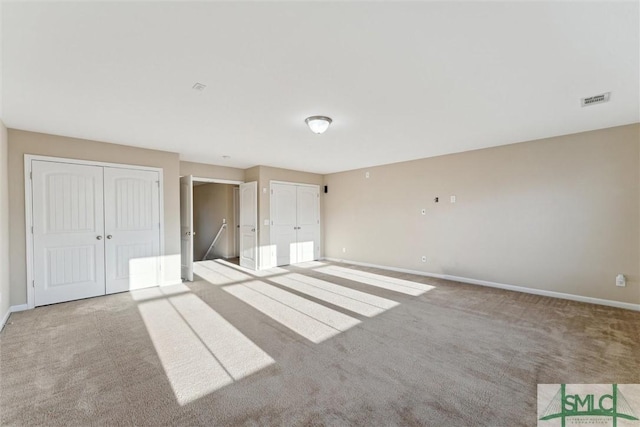 unfurnished bedroom featuring light colored carpet