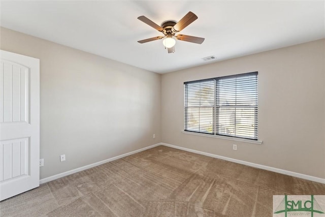 carpeted spare room with ceiling fan