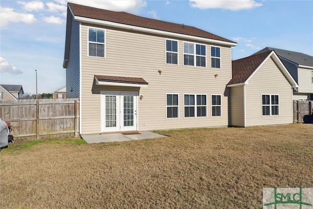 rear view of property featuring a lawn