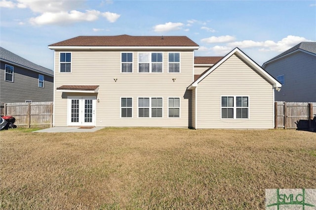 rear view of property with a lawn, a patio area, and french doors