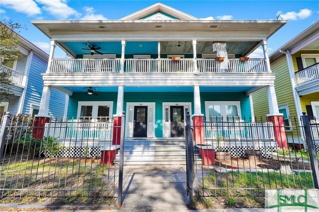 view of front of home with covered porch, a balcony, and ceiling fan