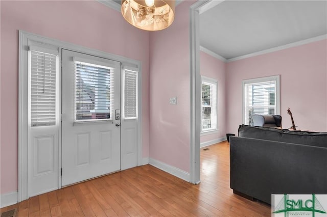 entrance foyer with light wood-type flooring and crown molding