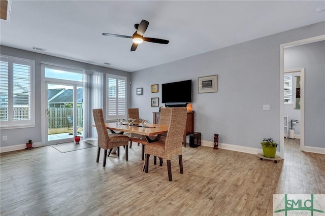 dining area with light hardwood / wood-style floors and ceiling fan