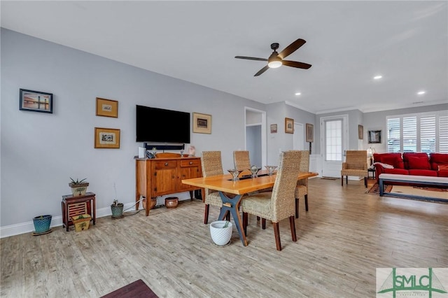 dining area with ceiling fan and light hardwood / wood-style floors