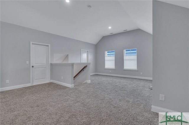 unfurnished living room featuring light colored carpet and vaulted ceiling