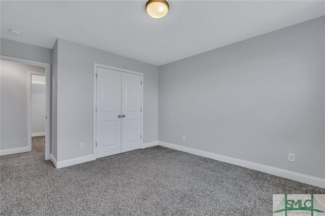 unfurnished bedroom featuring carpet flooring and a closet