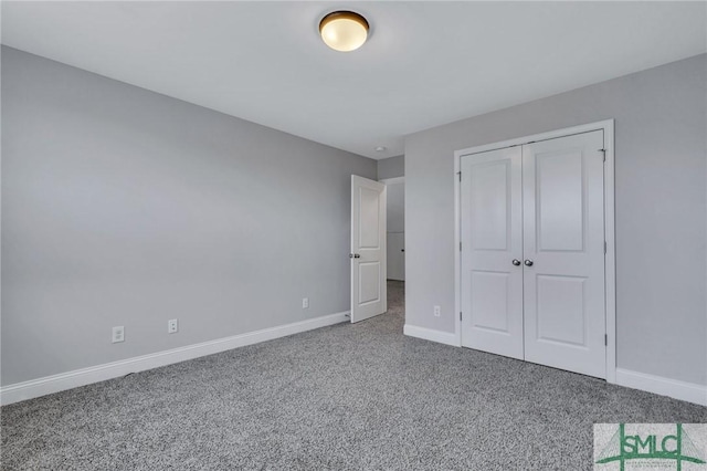 unfurnished bedroom featuring carpet flooring and a closet