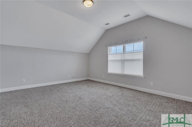 additional living space with carpet flooring and vaulted ceiling