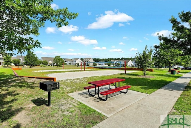 view of home's community with volleyball court and a yard