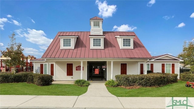 view of front of property with covered porch and a front lawn