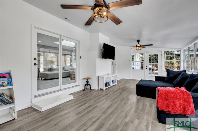 living room featuring light hardwood / wood-style floors and ceiling fan