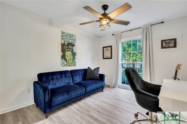 office with light hardwood / wood-style floors and ceiling fan