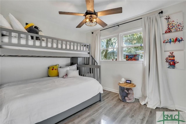 bedroom with light hardwood / wood-style floors and ceiling fan