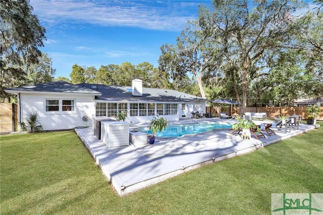 back of house featuring a lawn and a patio