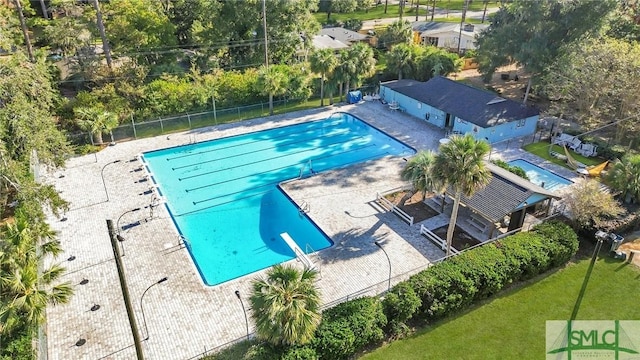 view of swimming pool featuring a diving board