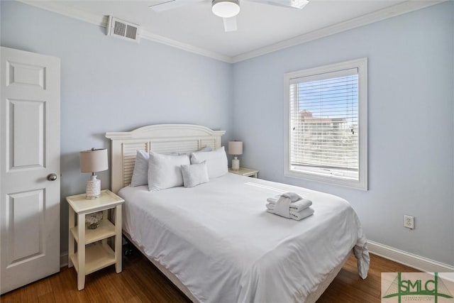 bedroom with ceiling fan, dark hardwood / wood-style flooring, and crown molding