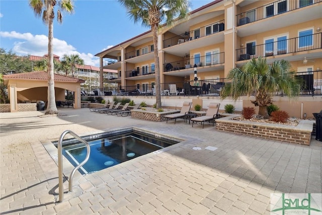 view of pool featuring a patio and a hot tub