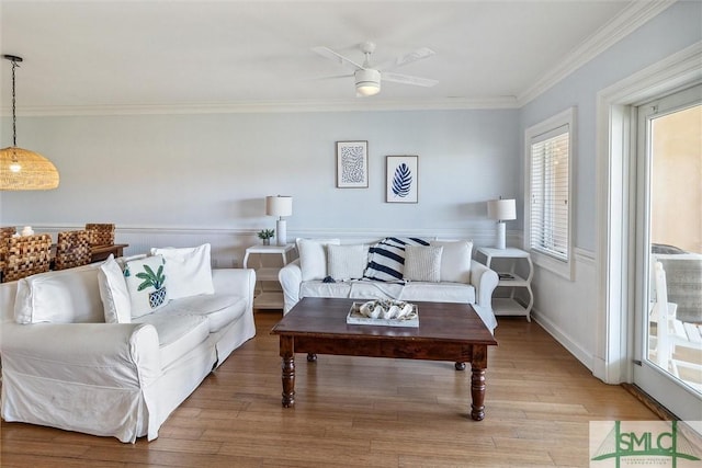 living room with ceiling fan, light hardwood / wood-style flooring, and ornamental molding