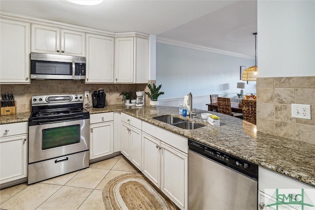 kitchen with light tile patterned floors, white cabinetry, and appliances with stainless steel finishes