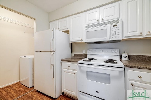 kitchen featuring white cabinets, white appliances, and dark wood-type flooring