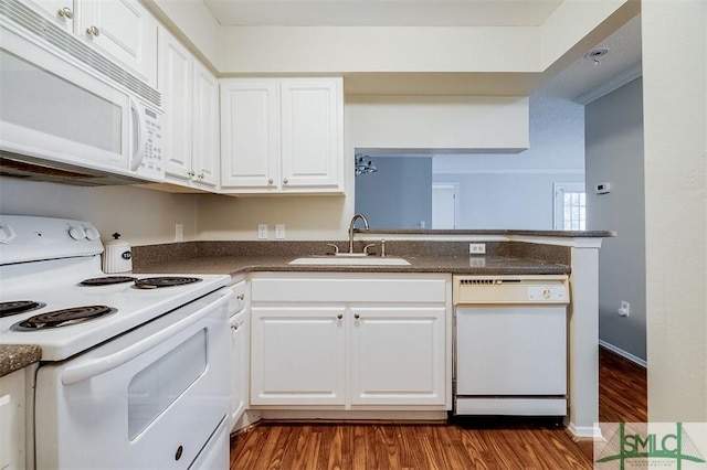 kitchen with sink, dark wood-type flooring, white appliances, white cabinets, and ornamental molding