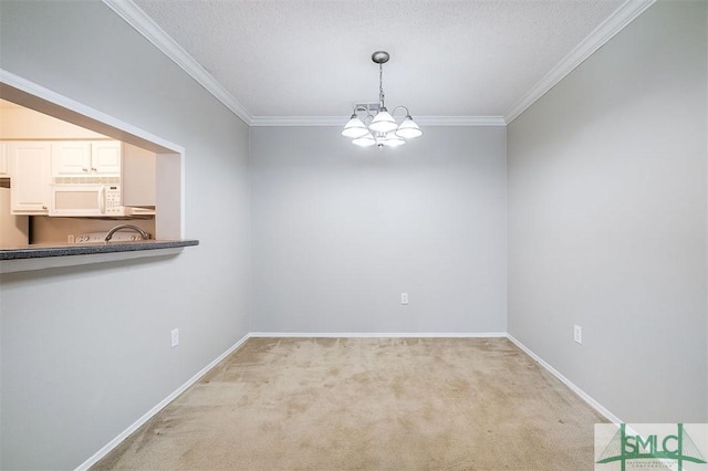 unfurnished dining area with light carpet, ornamental molding, a textured ceiling, and a notable chandelier