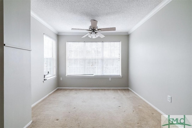 carpeted empty room with ceiling fan, plenty of natural light, and ornamental molding