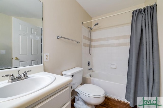 full bathroom with shower / bathtub combination with curtain, hardwood / wood-style flooring, vanity, and toilet