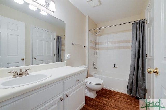 full bathroom with hardwood / wood-style floors, vanity, toilet, and shower / bath combination with curtain