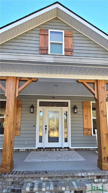 view of exterior entry with covered porch