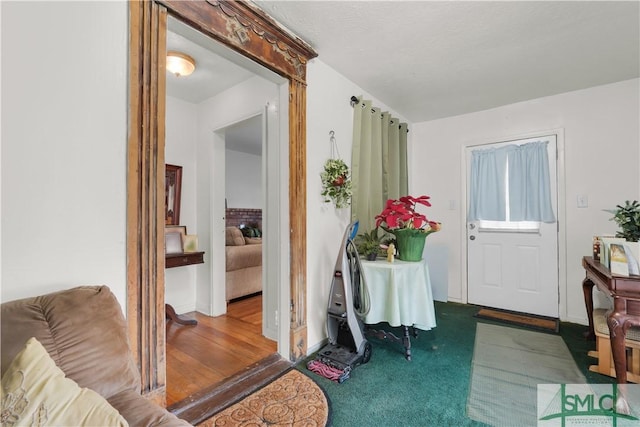 view of carpeted entrance foyer