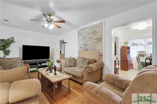 living room featuring ceiling fan and light wood-type flooring